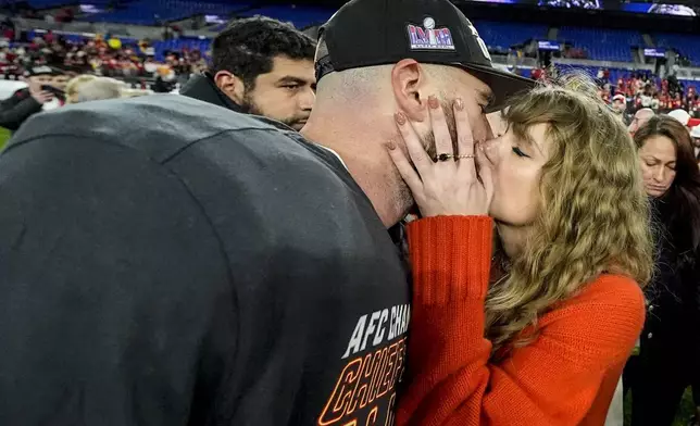 Taylor Swift kisses Kansas City Chiefs tight end Travis Kelce after an AFC Championship NFL football game against the Baltimore Ravens, Sunday, Jan. 28, 2024, in Baltimore. (AP Photo/Julio Cortez)