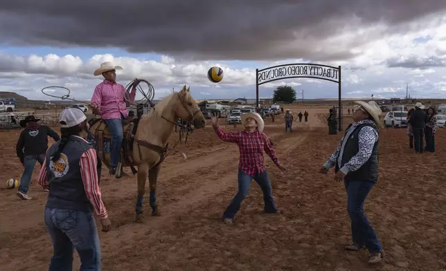 Navajo horsewomen circle pass a volleyball during the Western Navajo Fair in Tuba City, Ariz., Friday, Oct. 18, 2024. (AP Photo/Rodrigo Abd)