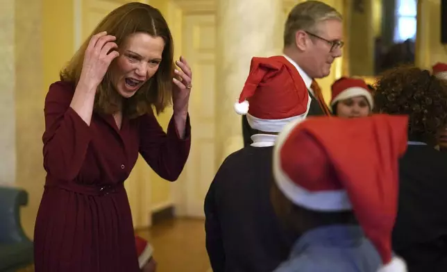 Victoria Starmer, wife of Britain's Prime Minister Keir Starmer, meets a guest as they host a children's Christmas party inside 10 Downing Street in London, Friday, Dec. 13, 2024. (AP Photo/Alberto Pezzali, Pool)