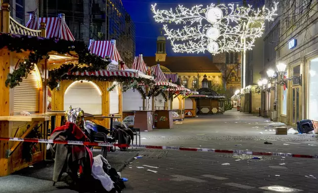 The Christmas market, where a car drove into a crowd on Friday evening, in Magdeburg, Germany, is empty on Saturday evening , Dec. 21, 2024. (AP Photo/Michael Probst)