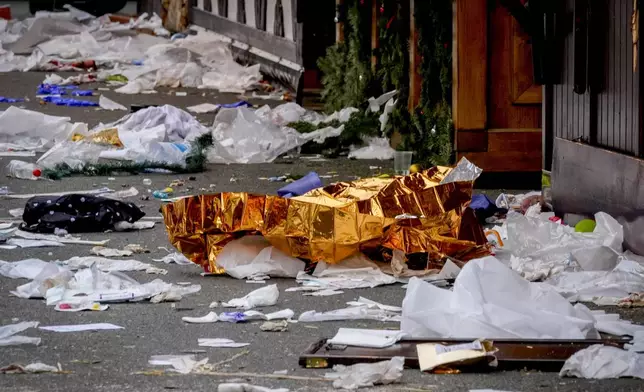 A blanket lies on a Christmas Market, where a car drove into a crowd on Friday evening, in Magdeburg, Germany, Saturday, Dec. 21, 2024. (AP Photo/Michael Probst)