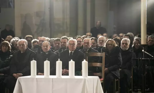 German President Frank-Walter Steinmeier, center, and Chancellor Olaf Scholza, center left, attend a memorial service for victims of Friday's Christmas Market attack, where a car drove into a crowd, in Magdeburg, Germany, Saturday, Dec. 21, 2024. (AP Photo/Ebrahim Noroozi)