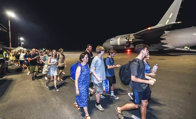 In this photo released by Australian Department of Defence, Australian citizens board a Royal Australian Air Force aircraft for a flight home from Bauerfield International Airport, Port Vila, Vanuatu, Wednesday, Dec. 18, 2024 following a powerful earthquake that struck just off the coast of Vanuatu in the South Pacific Ocean. (CPL Adam Abela/Australian Department of Defence via AP)