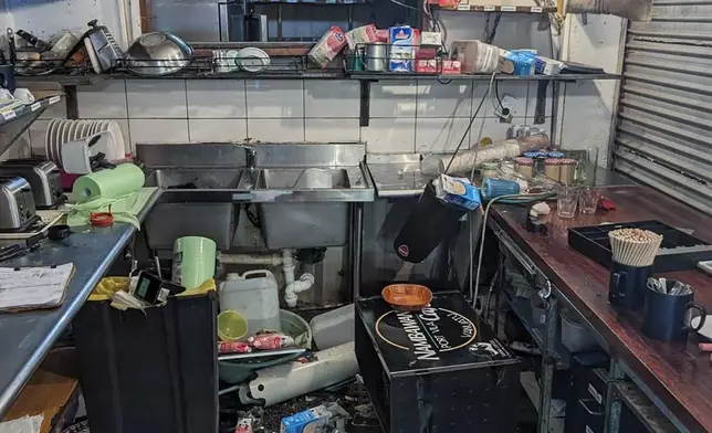 Damage to the inside of the Nambawan Cafe in Port Vila, Tuesday, Dec. 17, 2024, following a strong earthquake that struck just off the coast of Vanuatu in the South Pacific Ocean. (Ivan Oswald via AP)