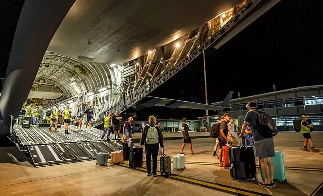 In this photo released by Australian Department of Defence, Australians disembark from an aircraft at RAAF Base Amberley, Australia after a flight home from Port Vila, Vanuatu, Wednesday, Dec. 18, 2024, following a powerful earthquake that struck just off the coast of Vanuatu in the South Pacific Ocean. (CPL Adam Abela/Australian Department of Defence via AP)