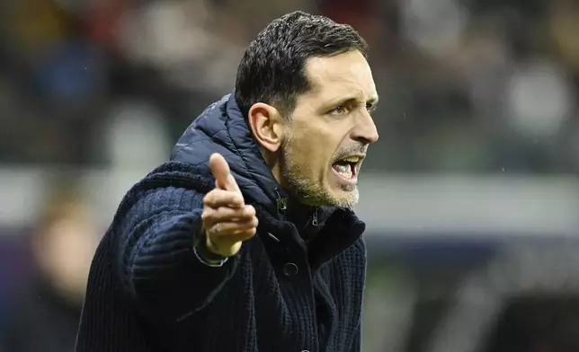 Frankfurt's head coach Dino Toppmoeller gestures during the German Bundesliga soccer match between Eintracht Frankfurt and FSV Mainz 05 in Frankfurt, Germany, Saturday, Dec. 21, 2024. (Uwe Anspach/dpa via AP)