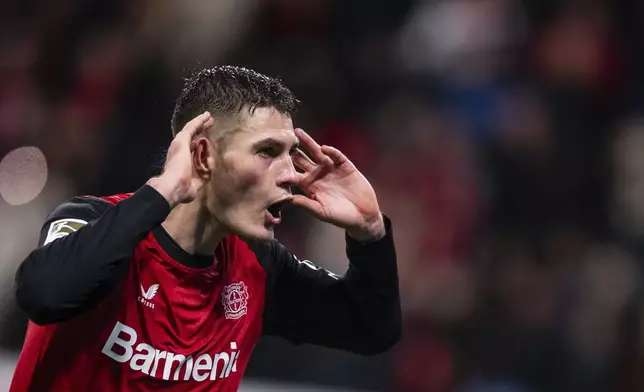 Leverkusen's Patrik Schick, second left, celebrates after scoring his side's third goal during the German Bundesliga soccer match between Bayer 04 Leverkusen and SC Freiburg in Leverkusen, Germany, Saturday, Dec. 21, 2024. (Marius Becker/dpa via AP)