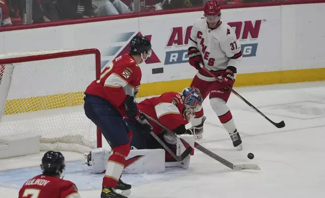 Florida Panthers goaltender Spencer Knight (30) stops a shot by Carolina Hurricanes right wing Andrei Svechnikov (37) during the second period of an NHL hockey game, Saturday, Nov. 30, 2024, in Sunrise, Fla. (AP Photo/Marta Lavandier)