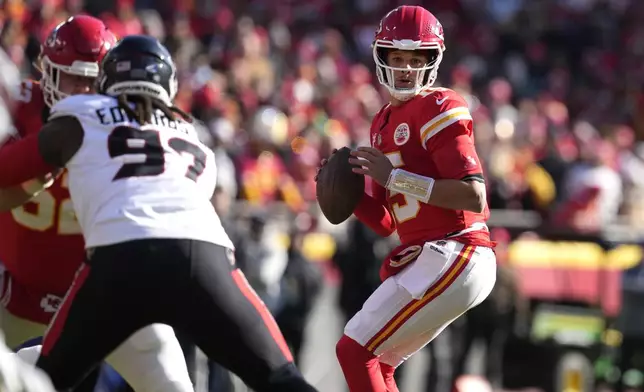 Kansas City Chiefs quarterback Patrick Mahomes drops back to pass during the first half of an NFL football game against the Houston Texans Saturday, Dec. 21, 2024, in Kansas City, Mo. (AP Photo/Ed Zurga)