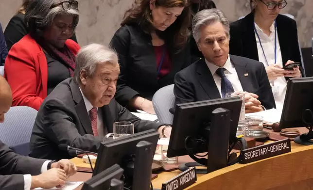 U.S. Secretary of State Antony Blinken, right, listens as UN Secretary General Antonio Guterres, left, delivers his remarks in the United Nations Security Council, Thursday, Dec. 19, 2024. US Ambassador Linda Thomas-Greenfield is seated, upper left. (AP Photo/Richard Drew)