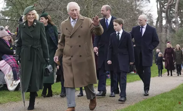 Britain's King Charles III waves to the crowd as he and Queen Camilla, Prince William, Prince George attend the Christmas day service at St Mary Magdalene Church in Sandringham in Norfolk, England, Wednesday, Dec. 25, 2024. (AP Photo/Jon Super)