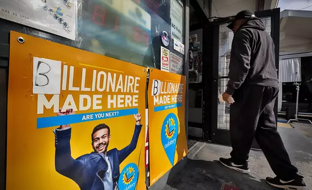 A customer arrives to buy lottery tickets at Joe's Service Center showing a $1.22 billion winning prize on Friday, Dec. 27, 2024 in Altadena, Calif. In 2022, the location had sold a $2.04 billion Powerball ticket. (AP Photo/Richard Vogel)