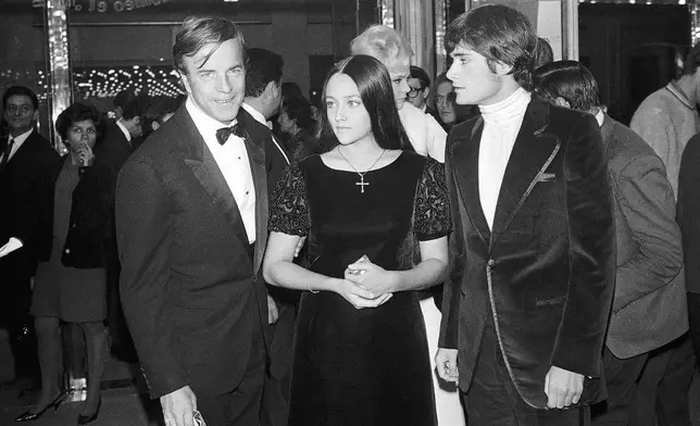 FILE - "Romeo and Juliette" movie director Franco Zeffirelli, left, actors Olivia Hussey, center, and Leonard Whiting are seen after the Parisian premiere of the film in Paris on Sept. 25, 1968. (AP Photo/Eustache Cardenas, File)