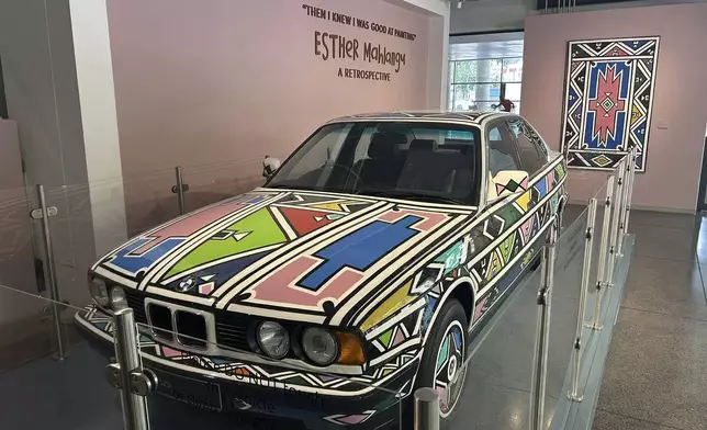Renowned South African artist Esther Mahlangu's iconic BMW 525i is seen on display at the Wits Arts Museum in Johannesburg, South Africa, Tuesday, Dec. 10, 2024. (AP Photo/ Mogomotsi Magome)