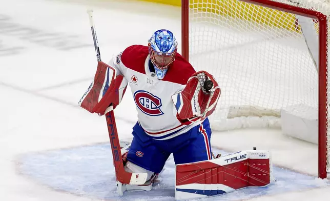 Montreal Canadiens goaltender Jakub Dobes (75) makes the save during the second period of an NHL hockey game against the Florida Panthers on Saturday, Dec. 28, 2024, in Sunrise, Fla. (David Santiago/Miami Herald via AP)