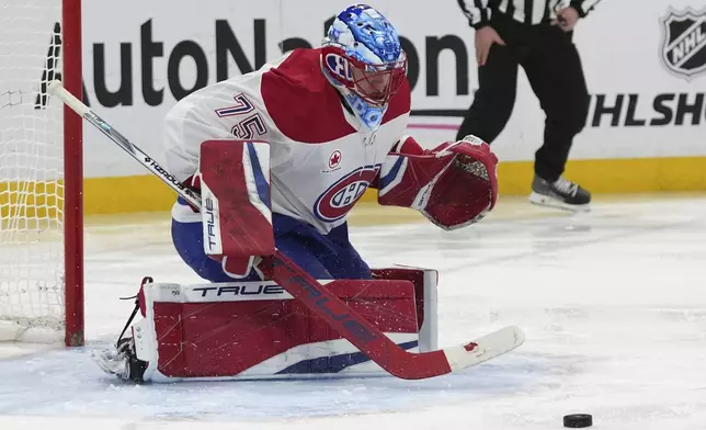 Montreal Canadiens goaltender Jakub Dobes (75) defends the goal during the second period of an NHL hockey game against the Florida Panthers, Saturday, Dec. 28, 2024, in Sunrise, Fla. (AP Photo/Lynne Sladky)