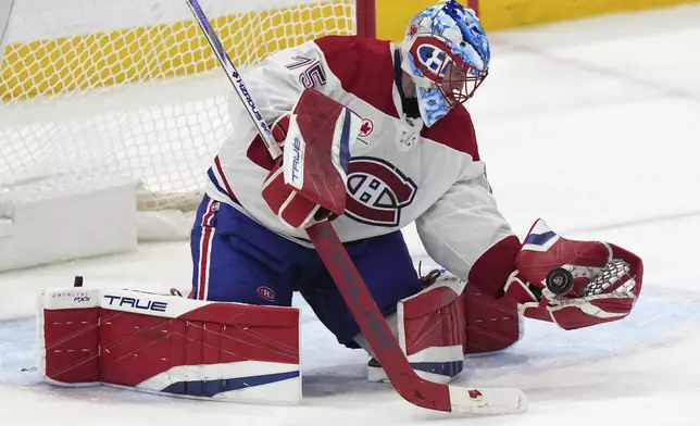 Montreal Canadiens goaltender Jakub Dobes (75) stops the puck during the third period of an NHL hockey game against the Florida Panthers, Saturday, Dec. 28, 2024, in Sunrise, Fla. (AP Photo/Lynne Sladky)