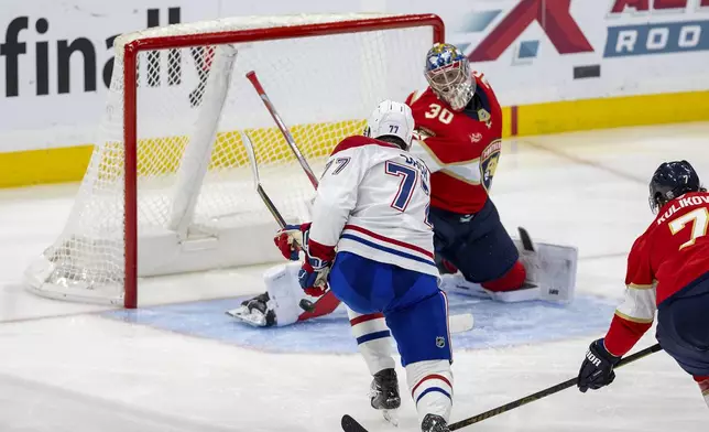 Montreal Canadiens center Kirby Dach (77) fires a shot past Florida Panthers goaltender Spencer Knight (30) to score a goal during the second period of an NHL hockey game on Saturday, Dec. 28, 2024, in Sunrise, Fla. (David Santiago/Miami Herald via AP)