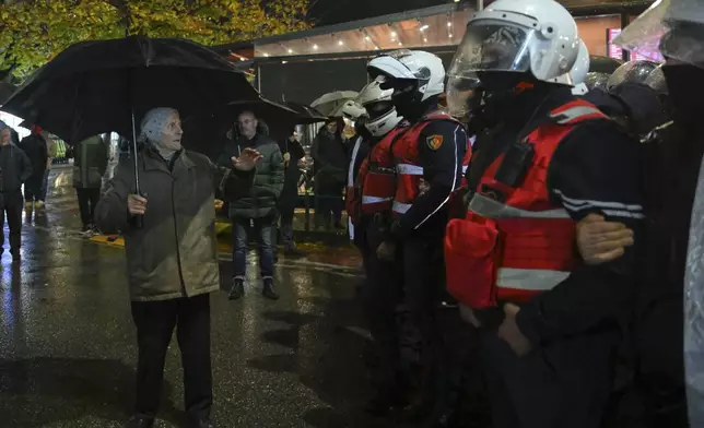 Police block opposition protesters during an anti-government rally asking for a technocratic caretaker Cabinet, in Tirana, Albania, Monday, Dec. 23, 2024. (AP Photo/Vlasov Sulaj)