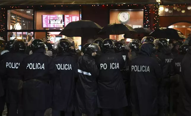 Police block opposition protesters during an anti-government rally asking for a technocratic caretaker Cabinet, in Tirana, Albania, Monday, Dec. 23, 2024. (AP Photo/Vlasov Sulaj)