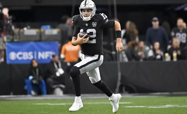 Las Vegas Raiders quarterback Aidan O'Connell runs with the ball against the Jacksonville Jaguars during the first half of an NFL football game Sunday, Dec. 22, 2024, in Las Vegas. (AP Photo/David Becker)