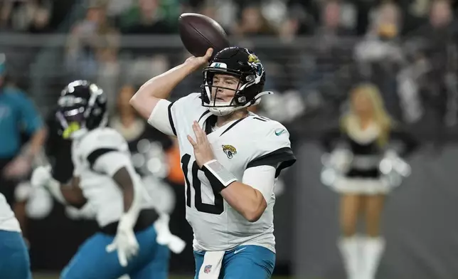 Jacksonville Jaguars quarterback Mac Jones throws against the Las Vegas Raiders during the first half of an NFL football game Sunday, Dec. 22, 2024, in Las Vegas. (AP Photo/John Locher)