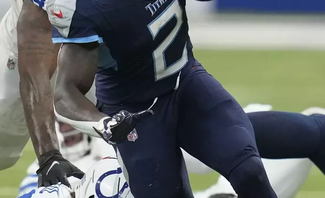 Tennessee Titans running back Tyjae Spears (2) runs the ball during the first half of an NFL football game against the Indianapolis Colts, Sunday, Dec. 22, 2024, in Indianapolis. (AP Photo/Darron Cummings)