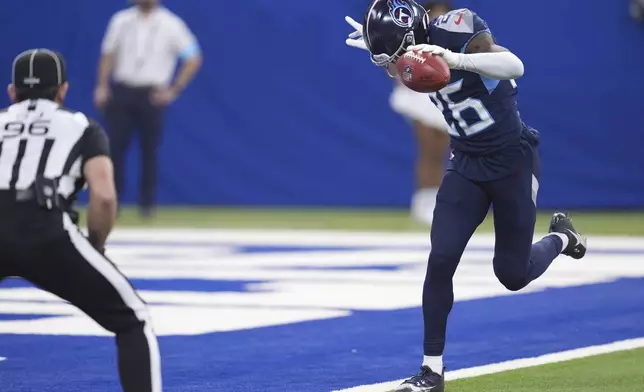 Tennessee Titans cornerback Justin Hardee Sr. (26) downs a punt at the goal line during the first half of an NFL football game against the Indianapolis Colts, Sunday, Dec. 22, 2024, in Indianapolis. (AP Photo/Michael Conroy)