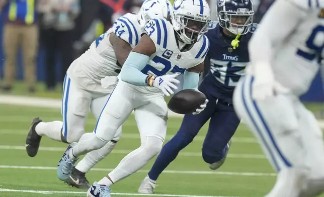 Indianapolis Colts cornerback Kenny Moore II (23) runs with an interception during the first half of an NFL football game against the Tennessee Titans, Sunday, Dec. 22, 2024, in Indianapolis. (AP Photo/Darron Cummings)