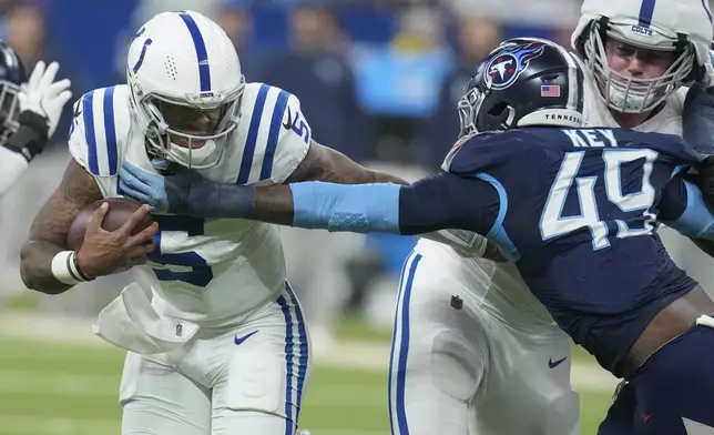 Indianapolis Colts quarterback Anthony Richardson (5) runs the ball past Tennessee Titans linebacker Arden Key (49) during the first half of an NFL football game Sunday, Dec. 22, 2024, in Indianapolis. (AP Photo/Darron Cummings)