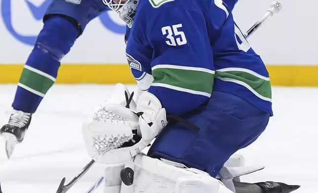 Vancouver Canucks goalie Thatcher Demko makes a save during the third period of an NHL hockey game against the Colorado Avalanch in Vancouver, Monday, Dec. 16, 2024. (Darryl Dyck/The Canadian Press via AP)