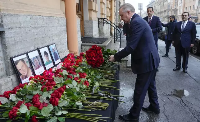 St. Petersburg Governor Alexander Beglov lays a bunch of flowers at the Consulate of Azerbaijan in the memory of victims of the Azerbaijan Airlines' Embraer 190 that crashed near the Kazakhstan's airport of Aktau, in St. Petersburg, Russia, Thursday, Dec. 26, 2024. (AP Photo/Dmitri Lovetsky)