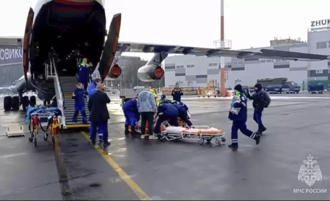 In this image taken from video released by the Russian Emergency Ministry Press Service, rescuers transport wounded passengers from a medical plane after the Azerbaijani Airline crashed, near the Kazakhstani city of Aktau, upon their arrival at the Zhukovsky airport outside Moscow, Russia, on Thursday, Dec. 26, 2024. (Russian Emergency Ministry Press Service via AP)