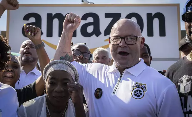 FILE - Teamsters General President Sean M. O'Brien, center, rallies with Amazon workers outside the Staten Island Amazon facility JFK8, June 19, 2024, in New York. (AP Photo/ Stefan Jeremiah, File)