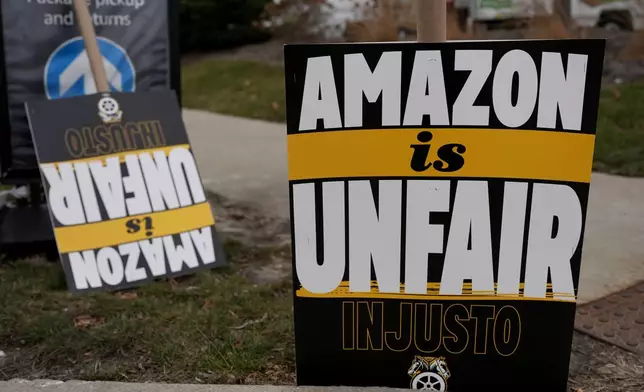 Signs are seen during a strike at Skokie (DIL7) Amazon Delivery station in Skokie, Ill., Thursday, Dec. 19, 2024. (AP Photo/Nam Y. Huh)