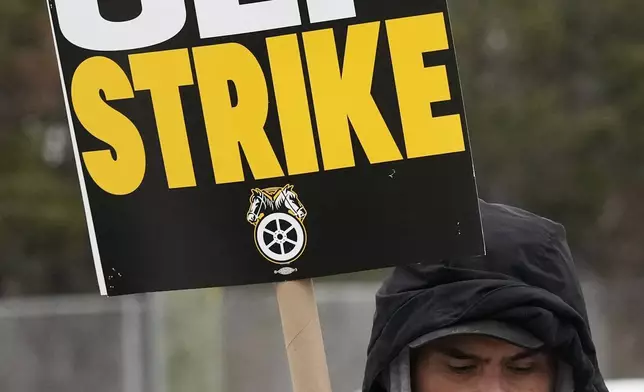 A striker holds a sign as Amazon workers picket outside the Skokie (DIL7) Amazon Delivery station in Skokie, Ill., Thursday, Dec. 19, 2024. (AP Photo/Nam Y. Huh)