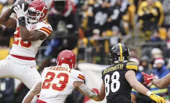 Kansas City Chiefs safety Justin Reid (20) intercepts the ball intended for Pittsburgh Steelers tight end Pat Freiermuth (88) during the first half of an NFL football game, Wednesday, Dec. 25, 2024, in Pittsburgh. (AP Photo/Matt Freed)