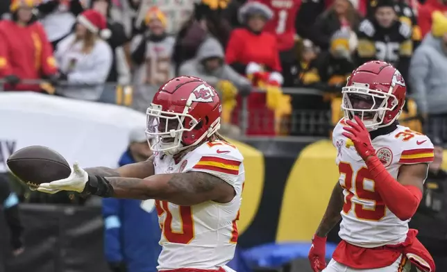 Kansas City Chiefs safety Justin Reid (20) celebrates his interception off Pittsburgh Steelers quarterback Russell Wilson during the first half of an NFL football game, Wednesday, Dec. 25, 2024, in Pittsburgh. (AP Photo/Gene J. Puskar)