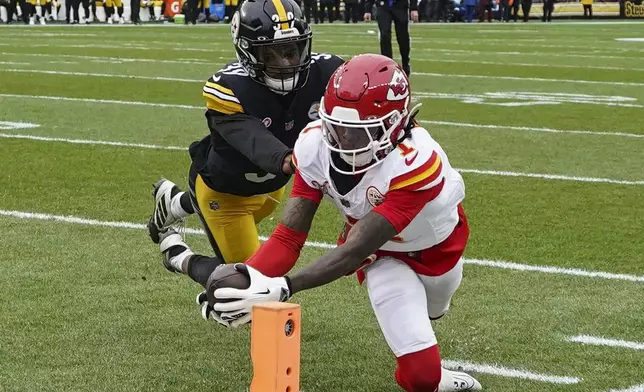 Kansas City Chiefs wide receiver Xavier Worthy (1) scores a touchdown against Pittsburgh Steelers safety Minkah Fitzpatrick (39) during the first half of an NFL football game, Wednesday, Dec. 25, 2024, in Pittsburgh. (AP Photo/Matt Freed)