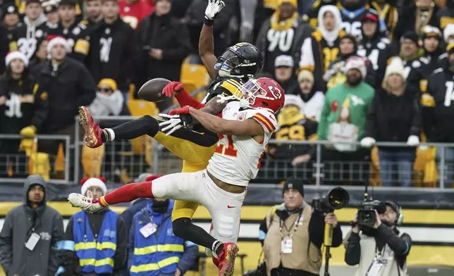 Kansas City Chiefs safety Jaden Hicks (21) breaks up a pass intended for Pittsburgh Steelers wide receiver George Pickens (14) during the second half of an NFL football game, Wednesday, Dec. 25, 2024, in Pittsburgh. (AP Photo/Matt Freed)