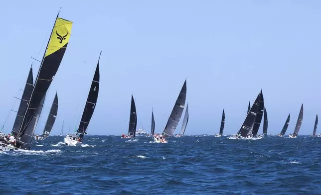 Competitors sail out of the heads following the start of the Sydney to Hobart yacht race in Sydney, Thursday, Dec. 26, 2024. (Mark Evans/AAP Image via AP).