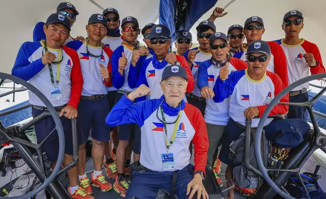 Skipper of Philippines entry Centennial, Ernesto Echauz, center, gestures with his crew ahead of the Sydney to Hobart yacht race in Sydney, Monday, Dec. 23, 2024. (Salty Dingo via AP)