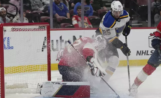 Florida Panthers goaltender Sergei Bobrovsky, left, defends the goal against St. Louis Blues center Jordan Kyrou (25) during the first period of an NHL hockey game, Friday, Dec. 20, 2024, in Sunrise, Fla. (AP Photo/Lynne Sladky)