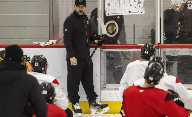 Chicago Blackhawks interim head coach Anders Sorensen directs players during NHL hockey practice at Fifth Third Arena, Friday, Dec. 6, 2024. (Ashlee Rezin/Chicago Sun-Times via AP)