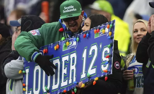 Seattle Seahawks fans cheer during the first half of an NFL football game against the Minnesota Vikings, Sunday, Dec. 22, 2024, in Seattle. (AP Photo/Lindsey Wasson)