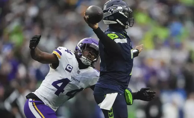 Seattle Seahawks quarterback Geno Smith (7) throws while pressured by Minnesota Vikings safety Josh Metellus (44) during the first half of an NFL football game, Sunday, Dec. 22, 2024, in Seattle. (AP Photo/Lindsey Wasson)