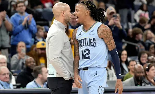 Memphis Grizzlies guard Ja Morant (12) reacts beside Brooklyn Nets head coach Jordi Fernandez, left, in the first half of an NBA basketball game Friday, Dec. 13, 2024, in Memphis, Tenn. (AP Photo/Brandon Dill)