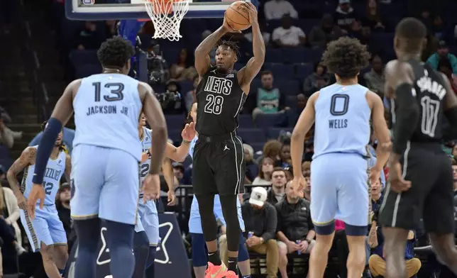 Brooklyn Nets forward Dorian Finney-Smith (28) handles the ball in the first half of an NBA basketball game against the Memphis Grizzlies Friday, Dec. 13, 2024, in Memphis, Tenn. (AP Photo/Brandon Dill)