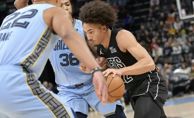 Brooklyn Nets forward Jalen Wilson (22) drives against Memphis Grizzlies guard Marcus Smart (36) in the first half of an NBA basketball game Friday, Dec. 13, 2024, in Memphis, Tenn. (AP Photo/Brandon Dill)