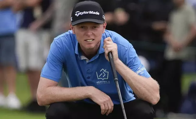 Ryggs Johnston of the United States lines up his putt on the 18th green during the final round of the Australian Open golf championship at the Kingston Heath Golf Club in Melbourne, Australia, Sunday, Dec. 1, 2024. (AP Photo/Asanka Brendon Ratnayake)